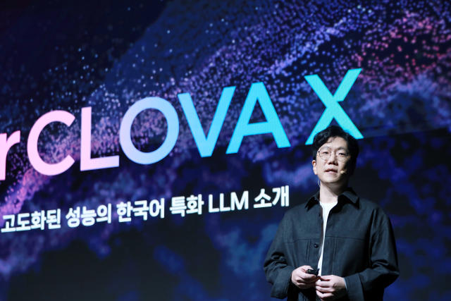 A man in a black jacket presents at a technology conference in front of a large backdrop displaying "HyperCLOVA X" and Korean text about a large language model (LLM). The visual theme features a cosmic background in purple and blue tones.